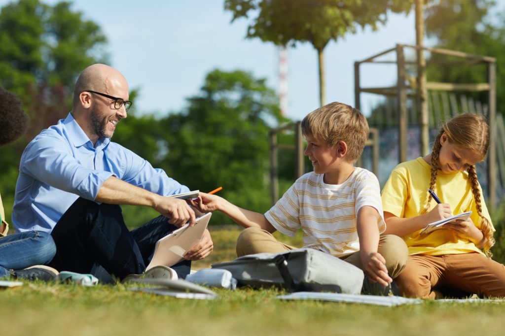 Smiling Male Teacher in Outdoor School Lesson